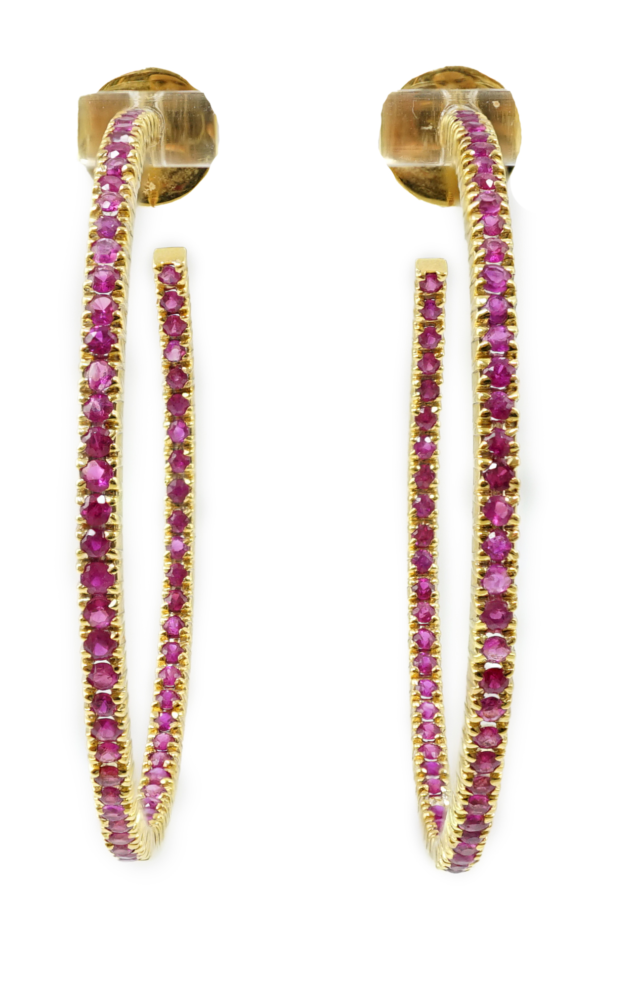 A large pair of gold and ruby chip set hoop earrings